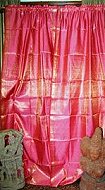 Spectacular Pair of silk Sari Saree Curtains / Drapes in Shimmering pink hues .We bring to you a stunning work of craftsmanship that combines exquisite shimmering pink silk saree fabric with gorgeous weave to create a lovely pair of drapes / curtains.The airy & delicate fabric add an airy feel to your room .The sensous fabric offers a perfect combination of privacy as well as a touch of exotica i DREAM OF JEANNIE BEDROOMS